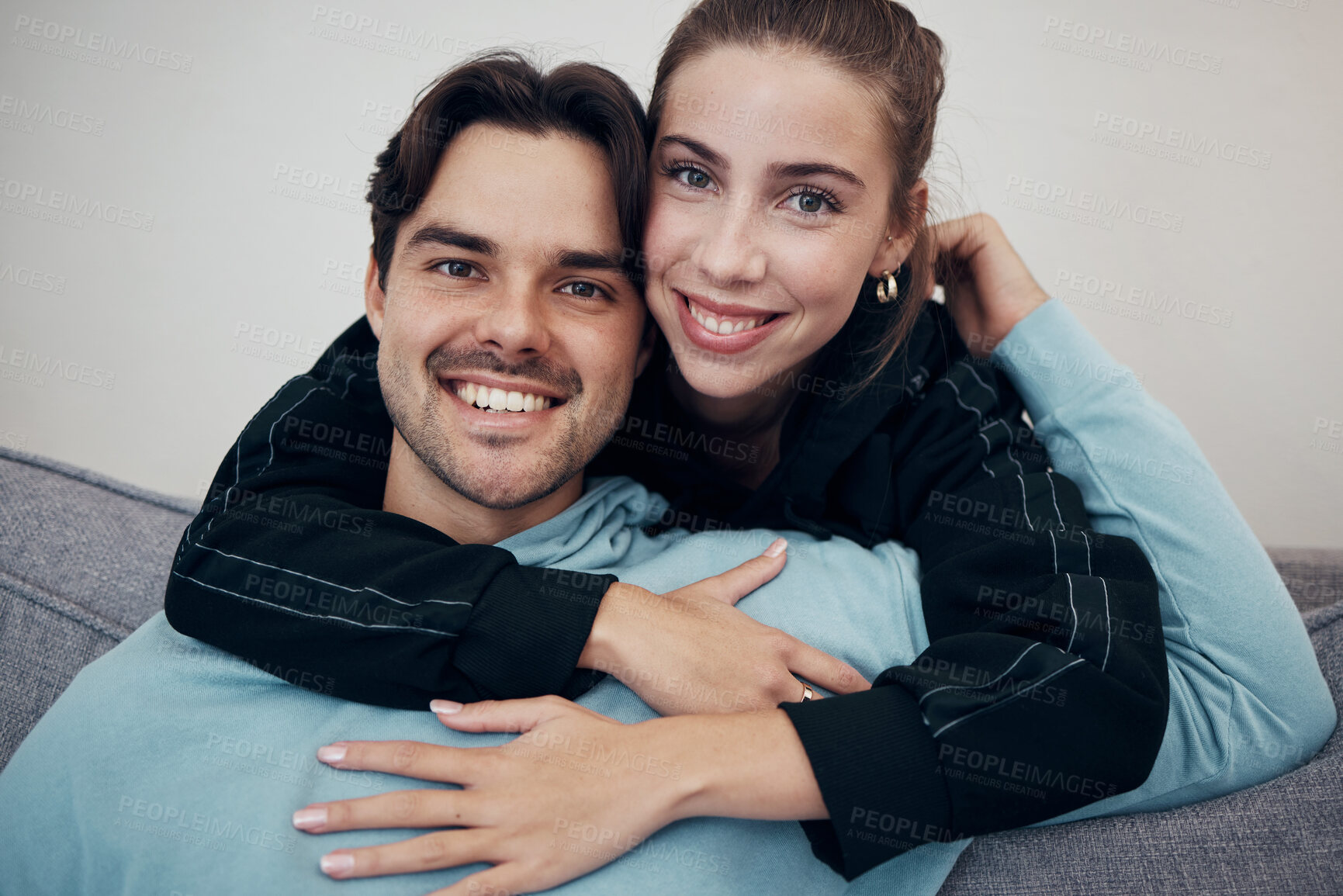 Buy stock photo Portrait, hug and smile with a couple on a sofa in the living room of their home together for bonding. Relax, love or date with a happy man and woman in their apartment for romance or relationship