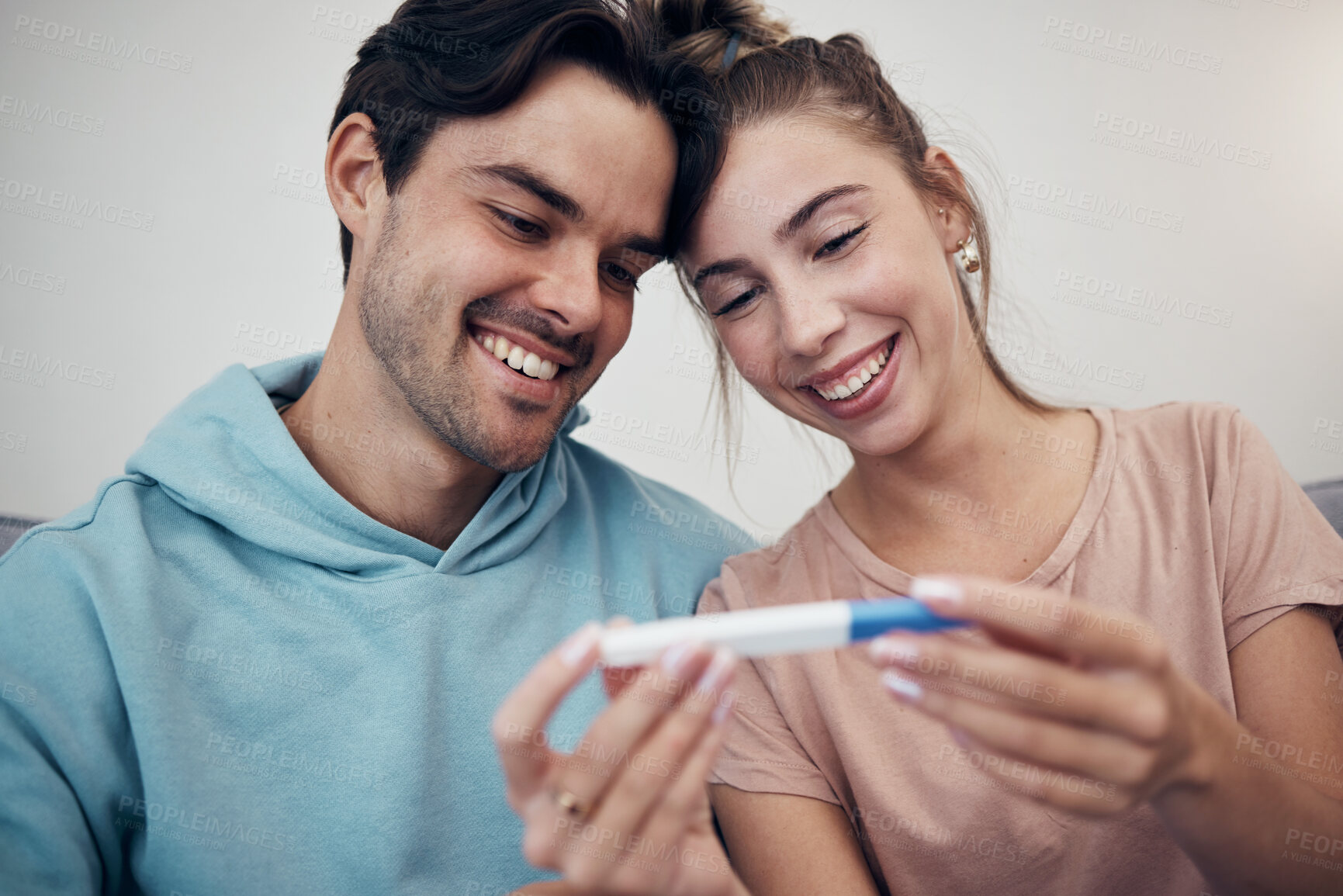 Buy stock photo Pregnancy, test and smile of couple in home, reading good news or check positive results. Pregnant, stick and happy man and woman in living room excited for success, future maternity or ivf fertility