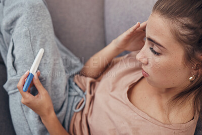 Buy stock photo Pregnancy test, sad and woman on sofa in home, reading bad news or negative results. Stick, serious and frustrated pregnant mother depressed in living room for fail, stress or anxiety for infertility