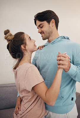 Buy stock photo Couple, together and embrace by dance in living room for romance, love or bond. Young man, woman and smile with happiness in home for marriage, relationship or care on honeymoon, vacation or holiday