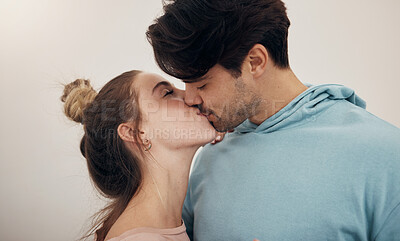 Buy stock photo Couple, date and kiss with love in studio, white background or mockup of happy, partnership or marriage. Romantic, people and bonding with man and woman in affection to show support and care together