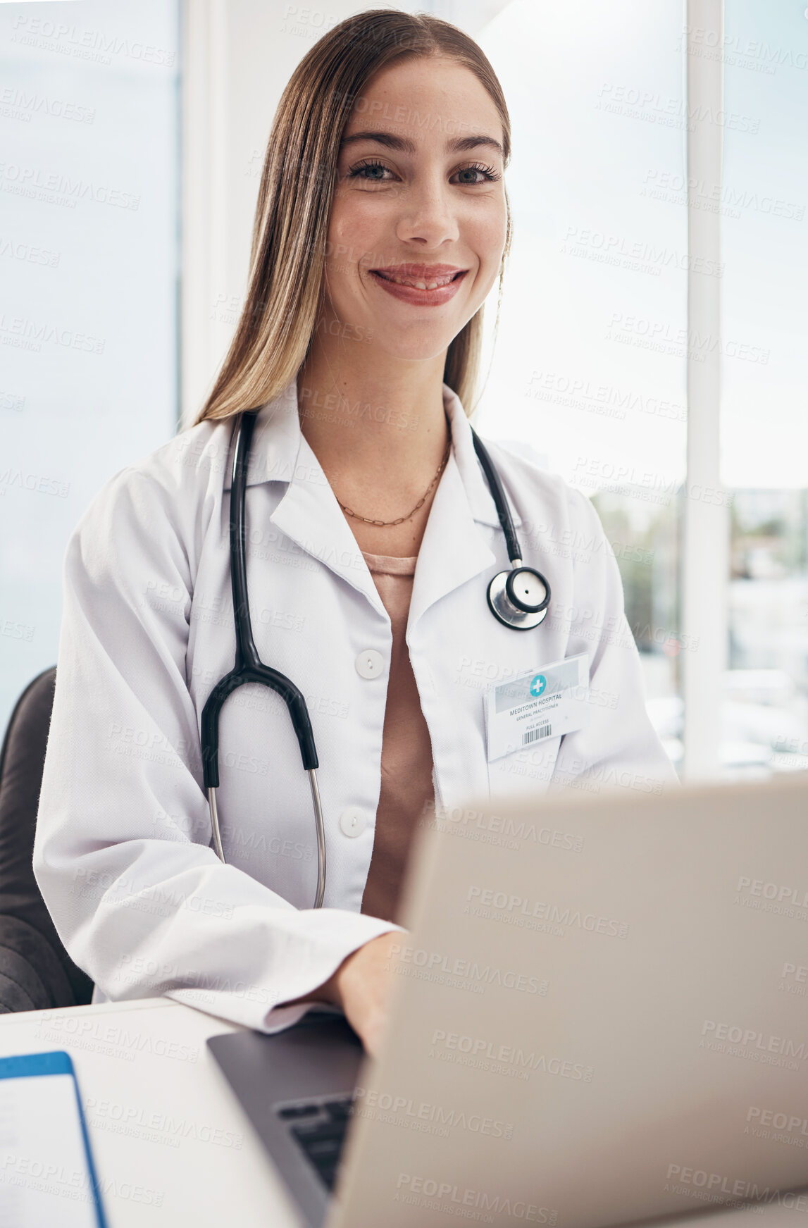 Buy stock photo Portrait, doctor and laptop with a woman in a hospital for healthcare, consulting or trust. Medical, smile and a happy young medicine professional typing at a desk in a clinic for cardiology