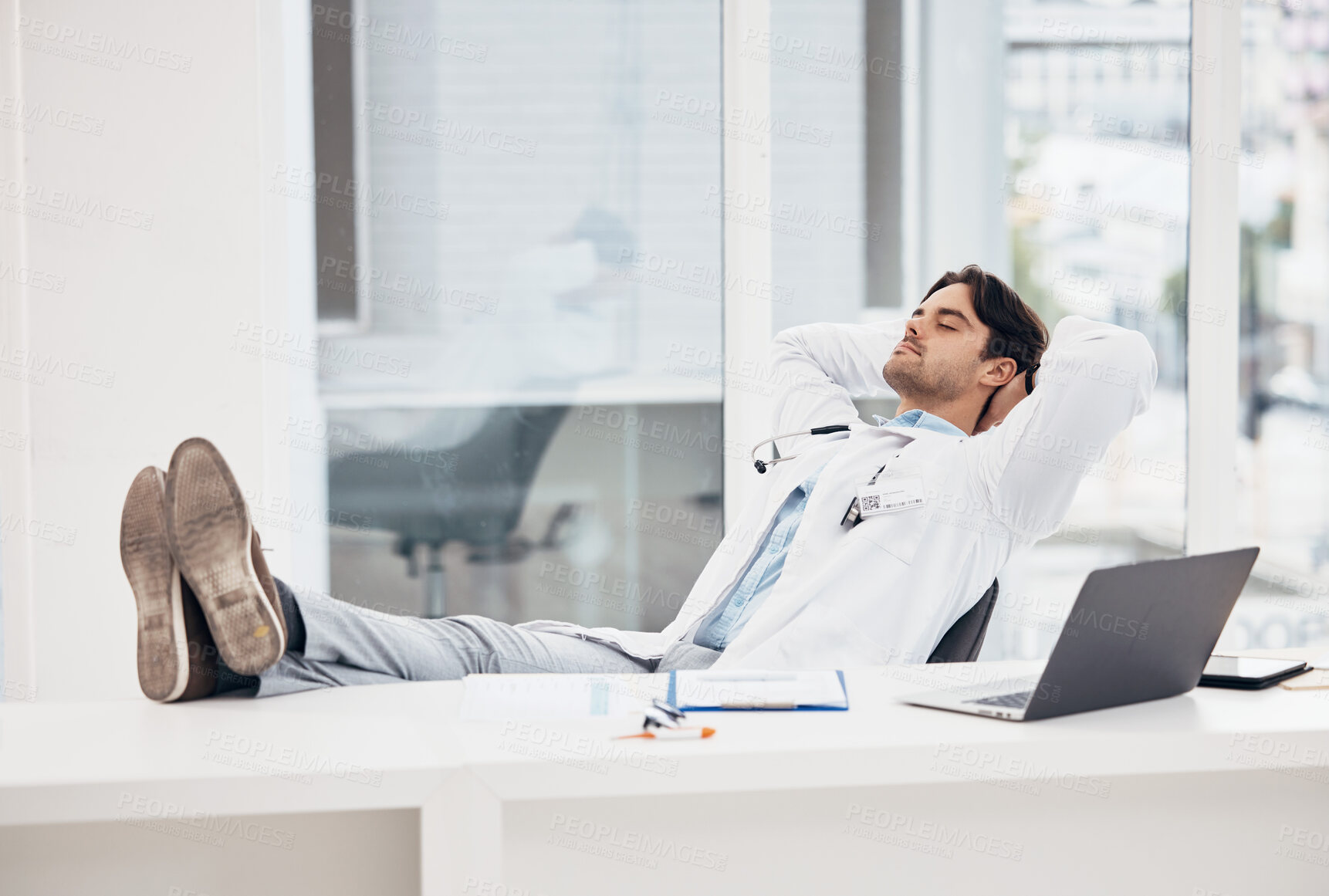 Buy stock photo Man, doctor and sleeping in relax for done, completion or finished at hospital office. Tired male person or medical surgeon chilling on break, rest or asleep lying with feet on work desk at clinic