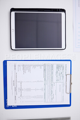 Buy stock photo Above, table, tablet and healthcare report at a hospital with results for a chart and medical paperwork. Desk, clinic work and technology for communication with a document for insurance in office