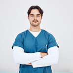 Nurse, portrait and man with arms crossed for healthcare in studio on white background or mock up space. Medicine, doctor and professional employee with serious face for service, trust and career