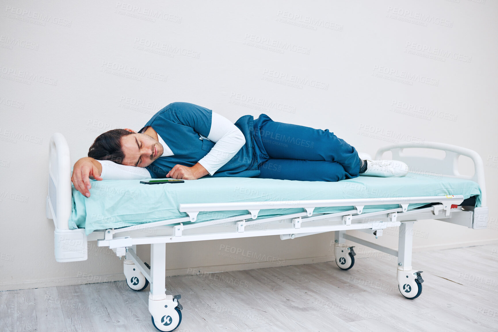 Buy stock photo Sleeping, hospital and tired doctor on bed for rest, nap and break for burnout, exhausted and fatigue. Healthcare, night shift and worker relax for medical service, wellness and stress in clinic