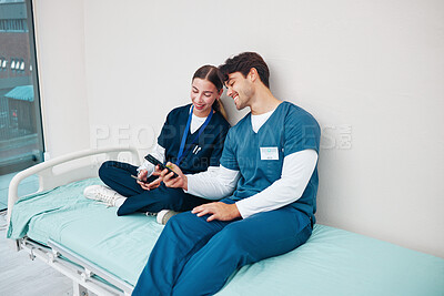 Buy stock photo Doctor, students and break on phone on a hospital, healthcare and clinic bed with social media. Media, mobile and happy young people together with rest from medical and nursing internship on a app