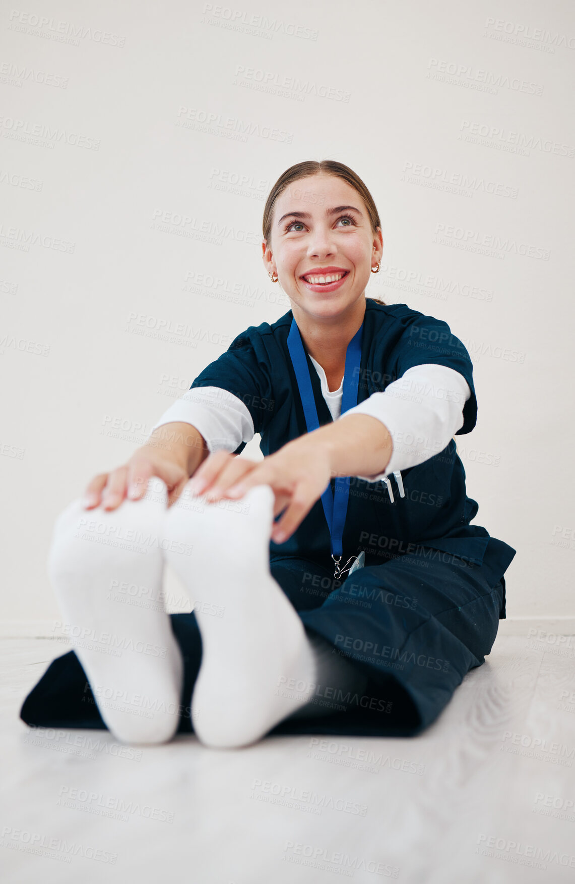Buy stock photo Stretching, legs and nurse with feet on floor in exercise, pilates or start of shift in clinic and healthcare. Work, preparation and warm up body for wellness, meditation and fitness in hospital