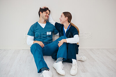 Buy stock photo Nurses, smile of couple and relax in hospital, talking and communication. Happy medical workers, man and woman on break, conversation and healthcare team support, love connection and mockup space
