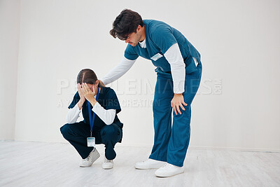 Buy stock photo Crying doctors, man and woman in team, clinic floor or stress for support, empathy or regret. Medic partnership, sad and depression for mistake, anxiety or healthcare in hospital for death in surgery