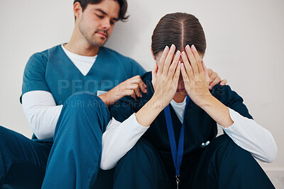 Buy stock photo Crying doctors, hospital floor and woman with man, support or empathy for regret, death or fail in surgery. Medic, partnership and burnout with depression, mistake or anxiety for healthcare in clinic