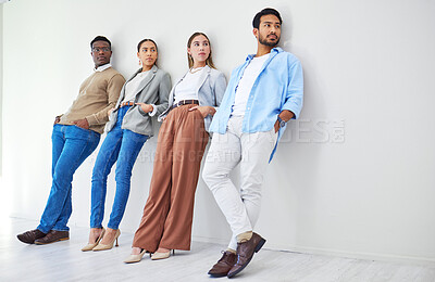 Buy stock photo Creative people, relax and waiting room on wall for recruiting, opportunity or thinking at office. Group of employees standing and leaning in row for hiring, team diversity or startup at workplace