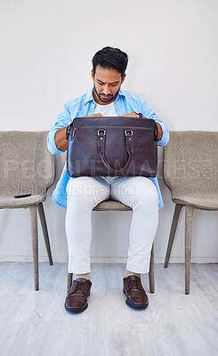 Buy stock photo Interview, man and job in waiting room, briefcase and looking for cv in bag by wall background. Business person, search and anxious to find resume, human resources and hiring or marketing opportunity