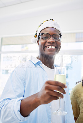 Buy stock photo Portrait, champagne and a business black man at an office party for a celebration event at work. Smile, Christmas and a happy young employee at his workplace with a hat for a festive company toast