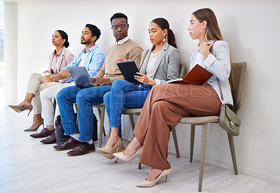Buy stock photo Business people, row and technology for interview, recruitment or hiring process in waiting room. Men, women and group together for career, onboarding or opportunity at company with diversity or web