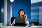 Business woman, call center and computer for communication, technical support and information technology advice at night. Professional agent, consultant or advisor speaking on laptop at tech company