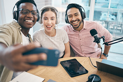 Buy stock photo Podcast, smile and group selfie of friends together bonding, live streaming and people recording broadcast in studio. Happy team of radio hosts take picture at table for social media or collaboration