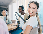 Radio, broadcast and portrait of woman in office with people recording, audio or streaming conversation. Podcast, hosting and presenter with headphones, microphone and happy group broadcasting news