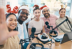 Christmas portrait, podcast and group selfie of friends, live streaming and people recording broadcast together in studio. Smile, radio host team and picture for xmas at table, holiday or celebration