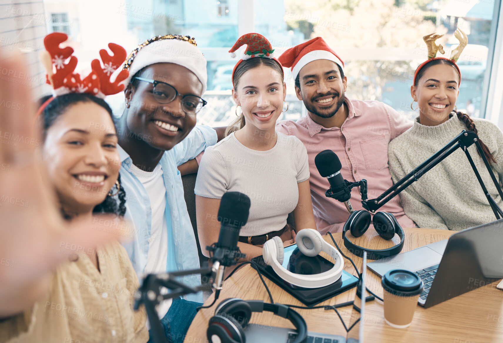 Buy stock photo Christmas portrait, podcast and group selfie of friends, live streaming and people recording broadcast together in studio. Smile, radio host team and picture for xmas at table, holiday or celebration