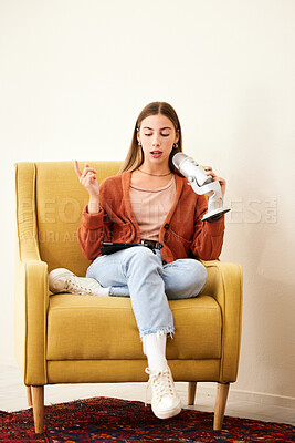 Buy stock photo Microphone, production and woman hosting a podcast on a chair by a wall in her modern home. Radio, broadcast and young female person hosting a journalism talk show in a recording space at her house.