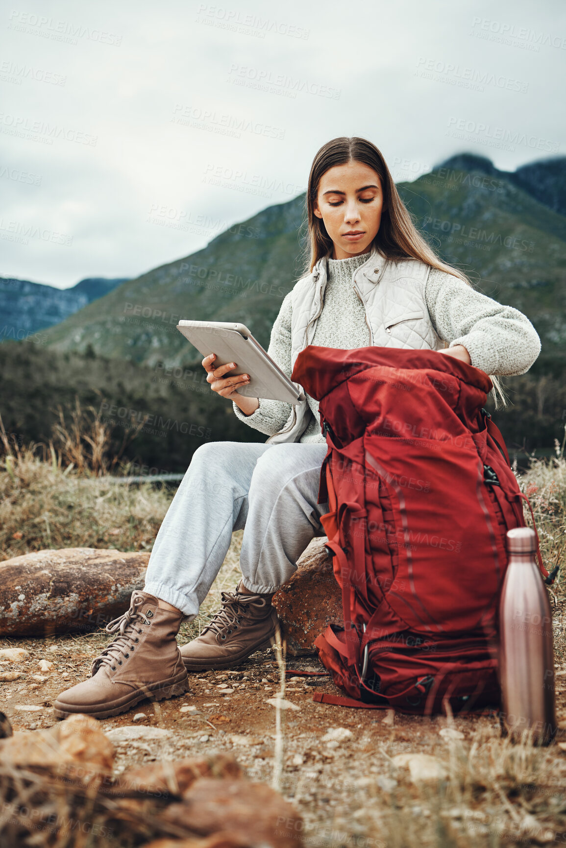 Buy stock photo Woman, hiking and tablet with backpack in nature for check, ready and thinking by hill, mountains and outdoor. Girl, luggage and trekking with bag, technology and ideas on adventure in countryside