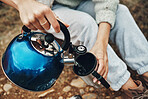 Camping, water and person with mug for coffee in morning for trekking, adventure and freedom. Travel, nature and hands with kettle for warm drink, beverage and tea on holiday, vacation and tourism