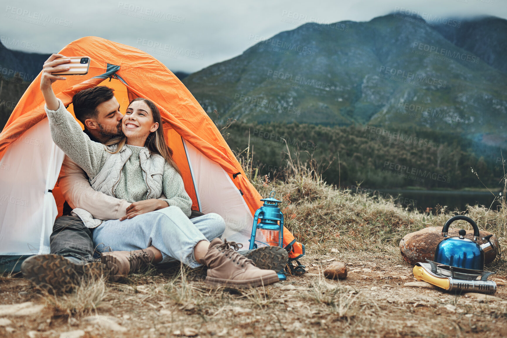 Buy stock photo Couple, tent and kiss in camping selfie, memory and holiday on web blog, morning and countryside. Man, woman and relax with vacation, social network post and adventure with love, outdoor and freedom