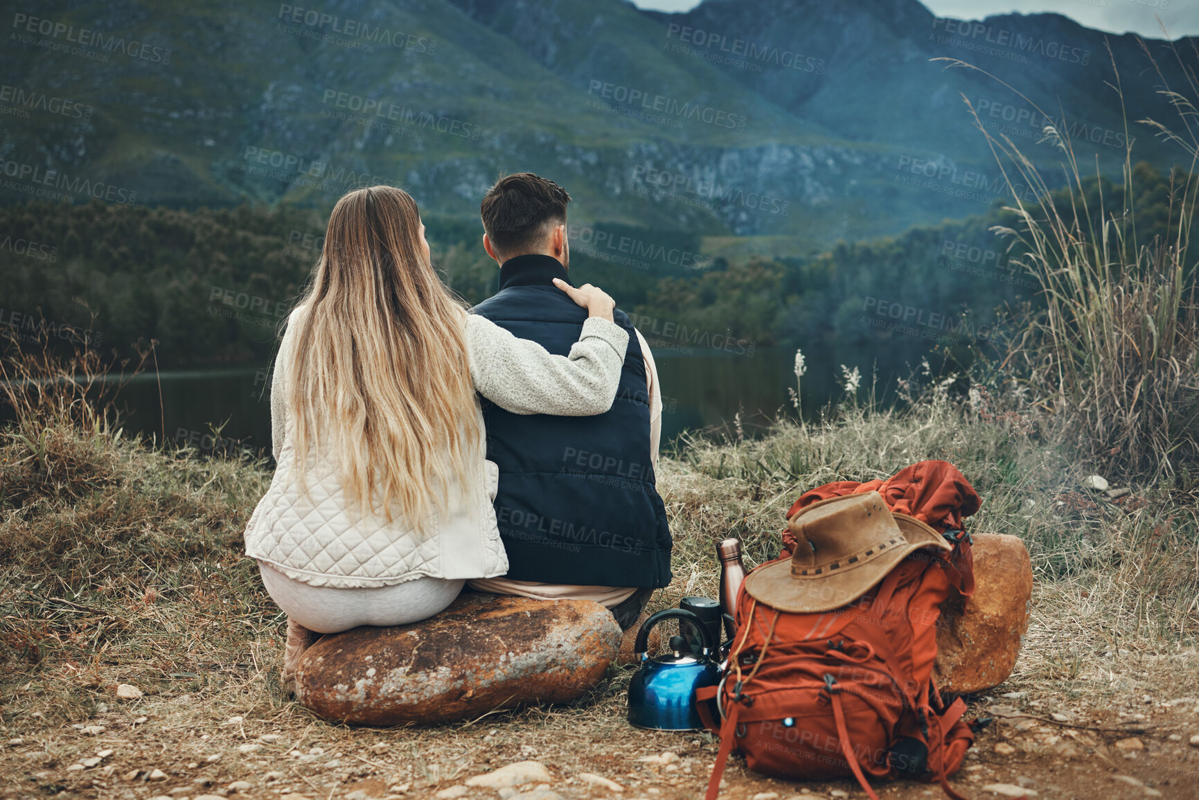 Buy stock photo Couple, hug and relax at lake on camping, adventure or travel in mountain, nature or environment. People, hiking and bonding together in embrace for support or care on journey in forest and woods