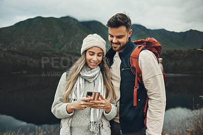 Buy stock photo Hiking, backpack and couple with phone in nature for social media, meme or text outdoor with freedom, smile and love. Camping, smartphone and happy people in forest on app for location, search or map