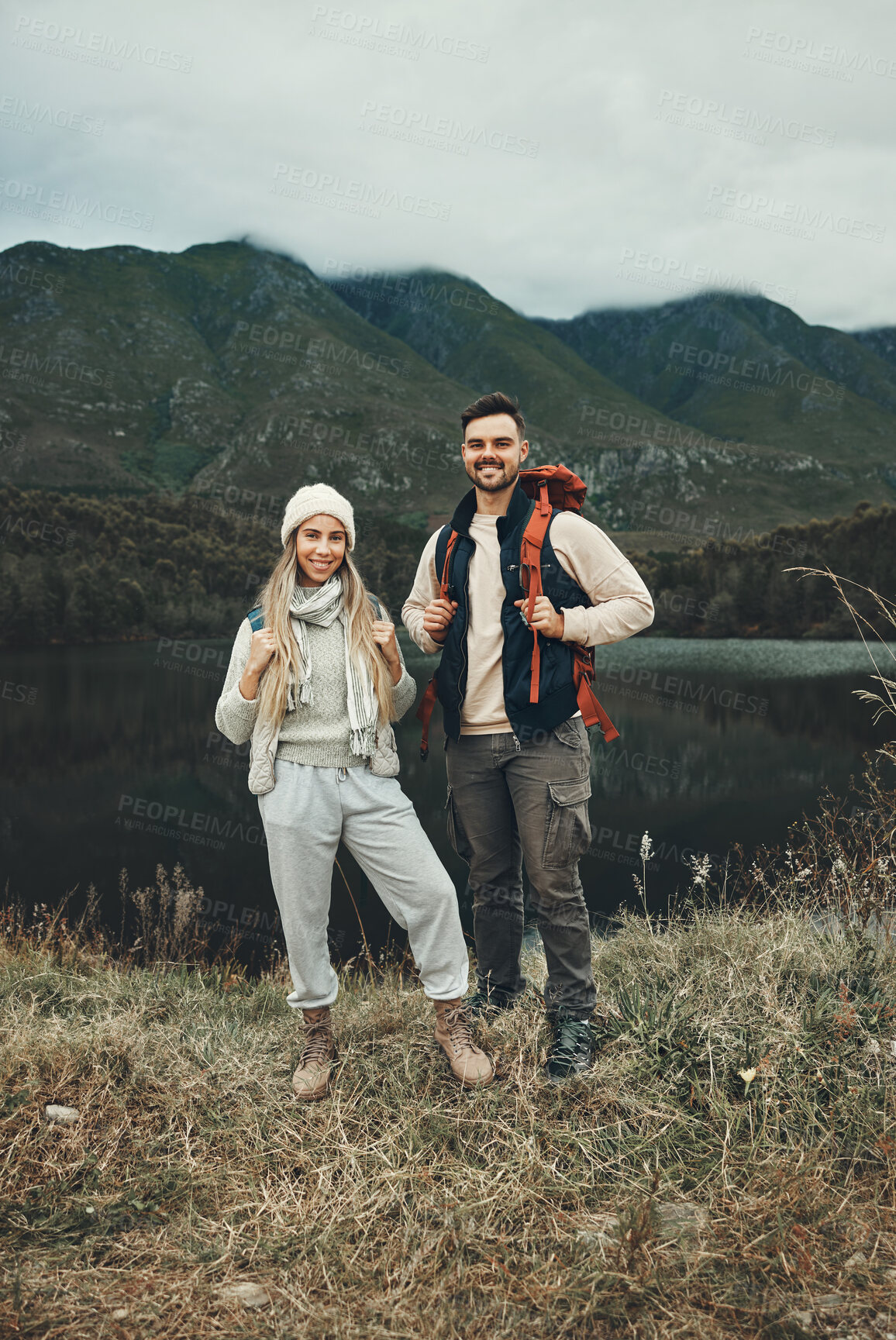 Buy stock photo Couple, hiking and portrait in nature with travel, mountain and backpacking with wilderness and explore outdoor. People camping, adventure and holiday with anniversary date, environment and trekking