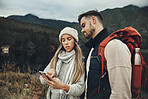 Couple, phone search and hiking in nature with online information for direction, guide or map on carbon footprint journey, Young people lost in mountains with backpack, travel and check for location