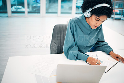 Buy stock photo Headphones, computer and businesswoman writing notes in office doing research for creative project. Notebook, technology and professional female designer work, plan and listen to music in workplace