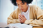 Bible, praying and woman in home for religion, Christian worship or reading to study. Person, holy book and meditation at desk for God, Jesus Christ and faith in spiritual gospel, praise and hope