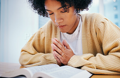 Bible, praying and woman in home for religion, Christian worship or reading to study. Person, holy book and meditation at desk for God, Jesus Christ and faith in spiritual gospel, praise and hope
