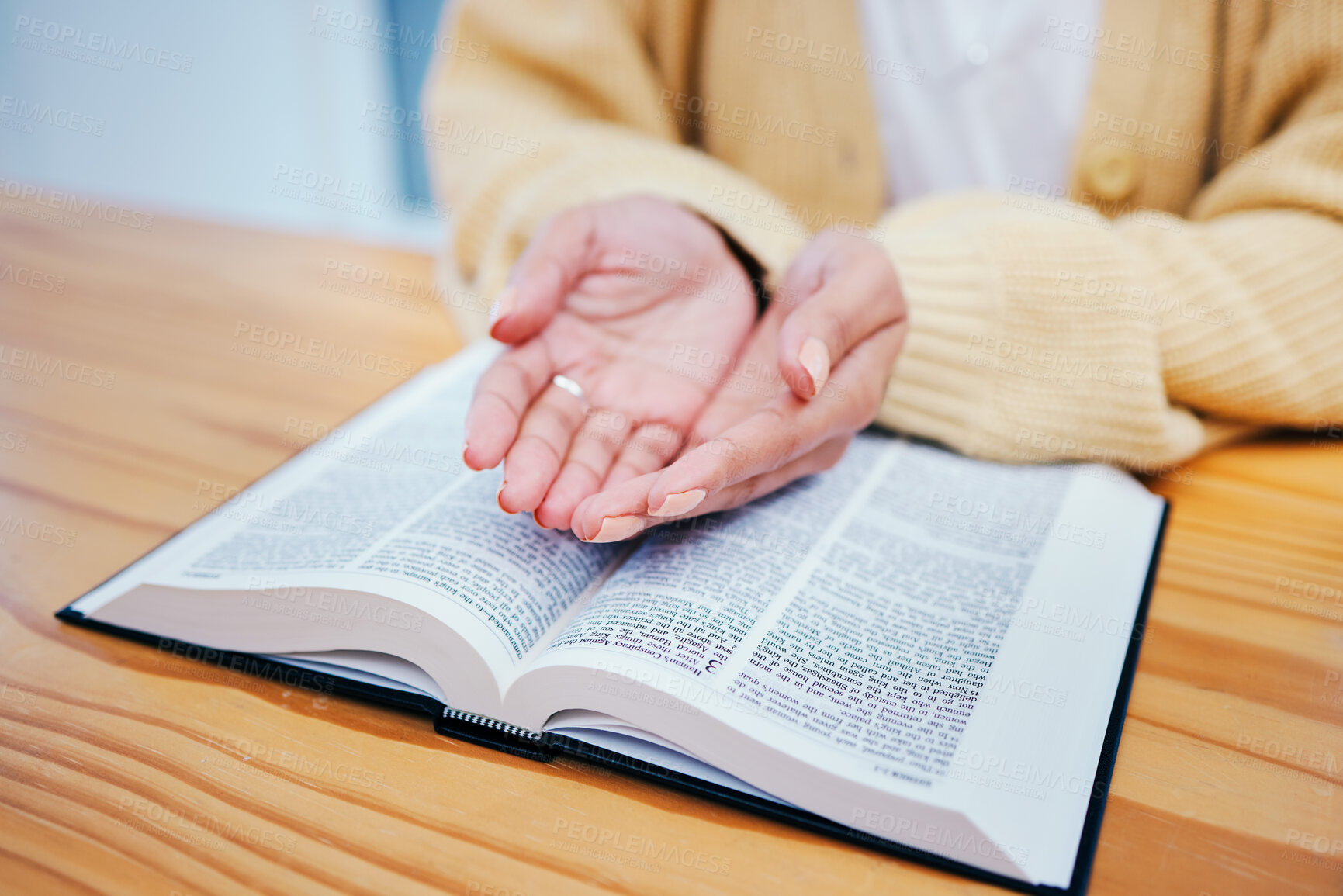 Buy stock photo Hands, bible and prayer at desk, religion and Christian worship in home at table. Closeup, holy book and woman in meditation for God, Jesus and Christ for faith in spiritual gospel, praise or hope