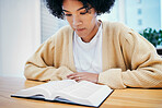 Bible, reading and woman studying religion at desk in home, Christian faith and knowledge of God. Praise, learning and girl at table with holy book, gospel and inspiration for prayer in apartment.