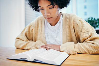 Buy stock photo Bible, reading and woman studying religion at desk in home, Christian faith and knowledge of God. Praise, learning and girl at table with holy book, gospel and inspiration for prayer in apartment.