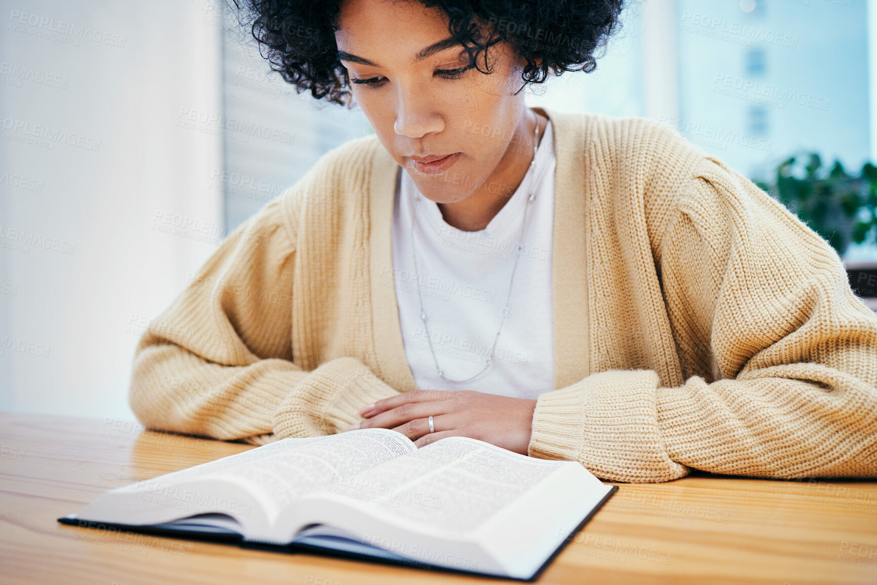 Buy stock photo Bible, reading and woman studying religion at desk in home, Christian faith and knowledge of God. Praise, learning and girl at table with holy book, gospel and inspiration for prayer in apartment.