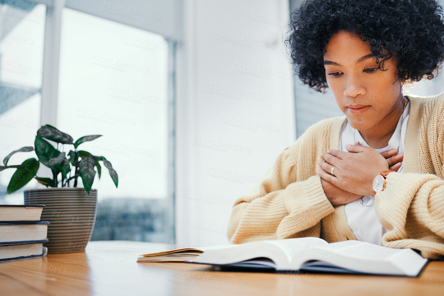 Buy stock photo Bible, prayer and woman studying religion at desk in home, Christian faith and knowledge of God for hope. Reading, praise and girl at table with holy book, learning gospel for inspiration or theology