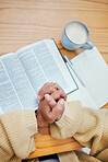 Bible, notes and hands of woman in prayer at desk in home, Christian faith or knowledge of God from above. Reading, study and girl at table with holy book, learning gospel for inspiration or theology