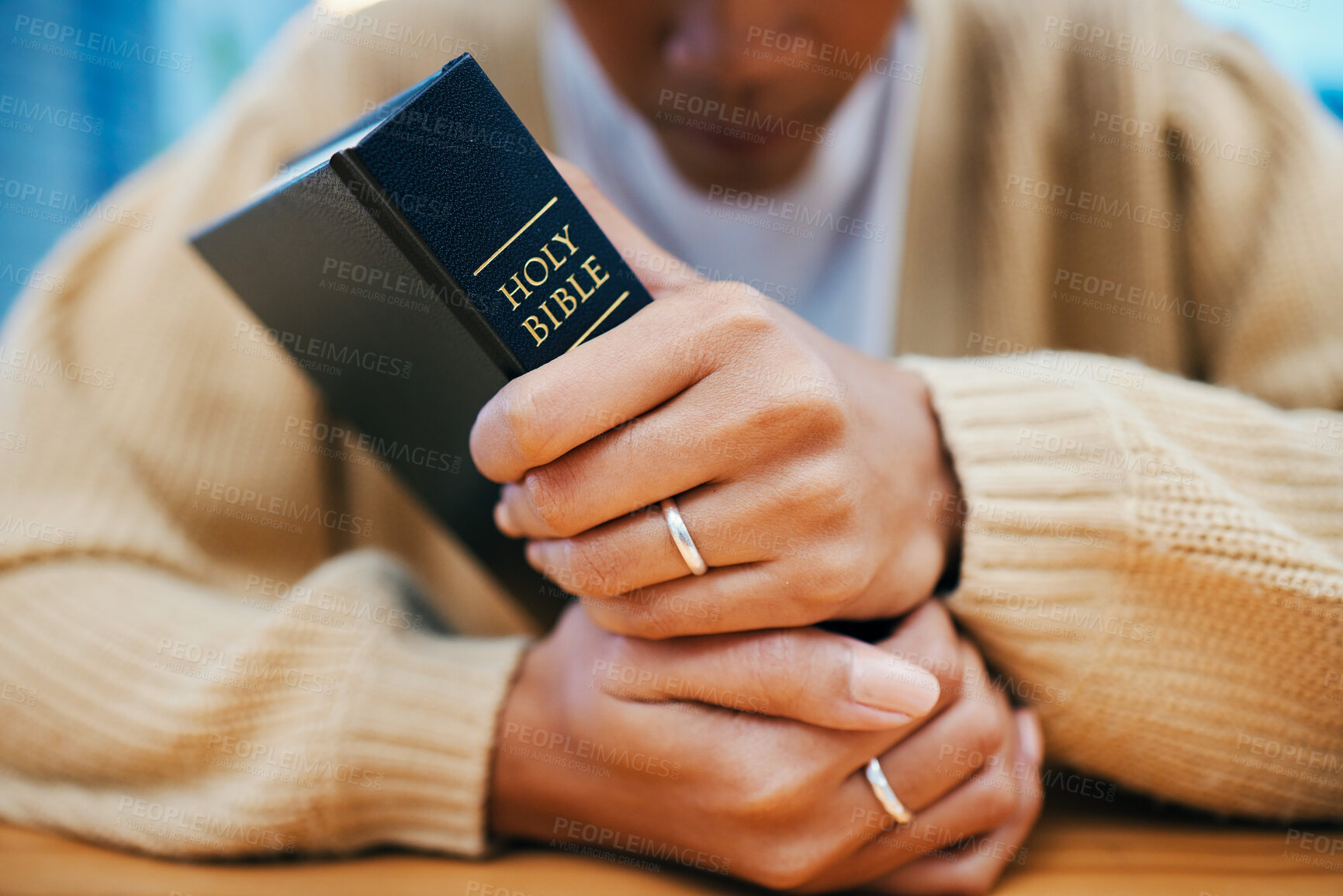 Buy stock photo Hands, bible and prayer at desk, religion and Christian worship in home at table. Closeup, holy book and woman in meditation for God, Jesus and Christ for faith in spiritual gospel, praise or hope