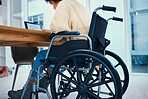 Business, desk and worker in wheelchair in office, working on project, report and proposal. Corporate, professional and person with disability with technology for internet, research and browse online