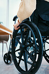 Hand, wheelchair and person with a disability closeup in a home for recovery or mobility from the back. Healthcare, medical and injury with a patient in a hospital or clinic for rehabilitation