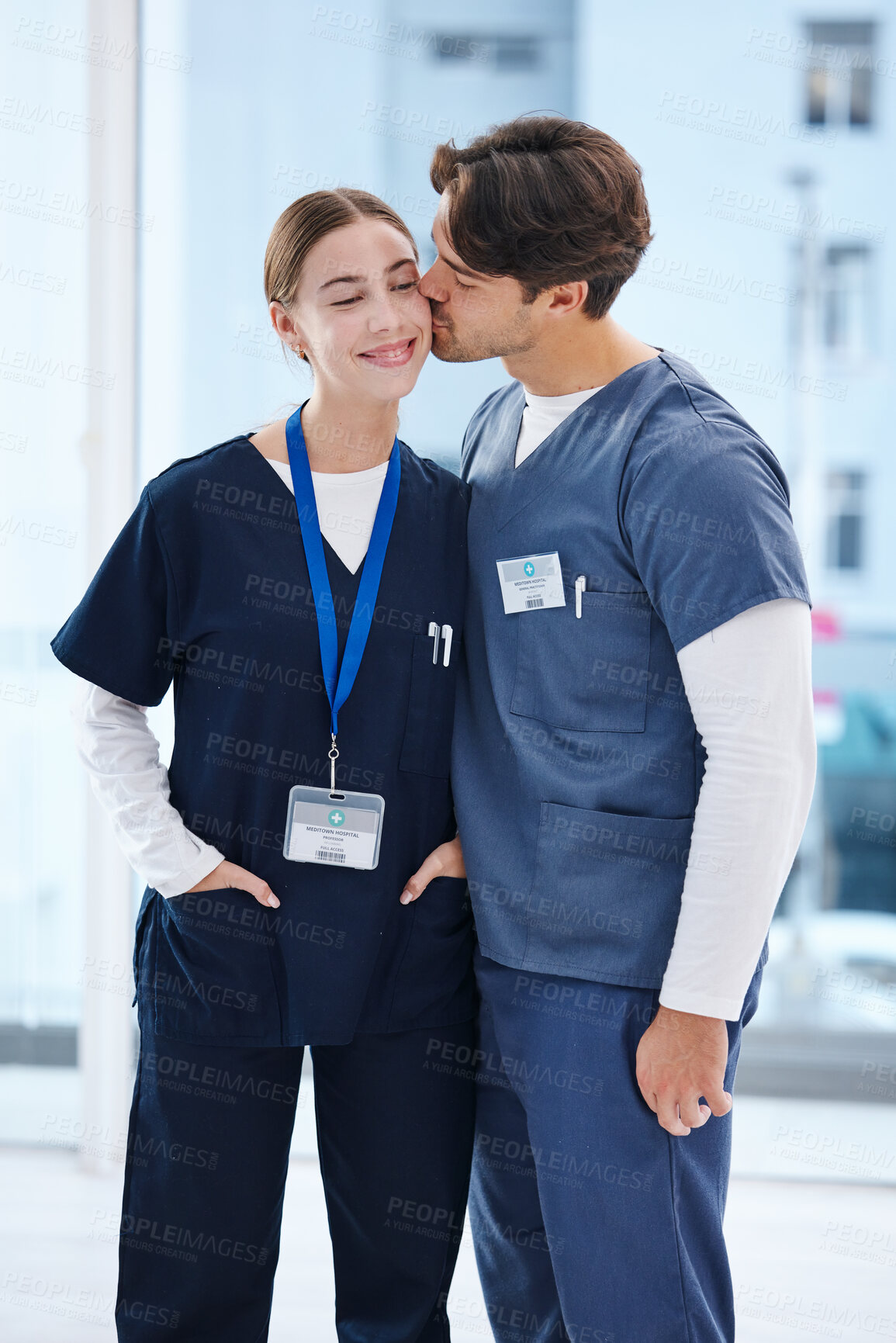 Buy stock photo Couple, hospital and doctors kiss for love, happy relationship and work romance in clinic. Healthcare team, collaboration and man and woman embrace in medical service, support and medicare career