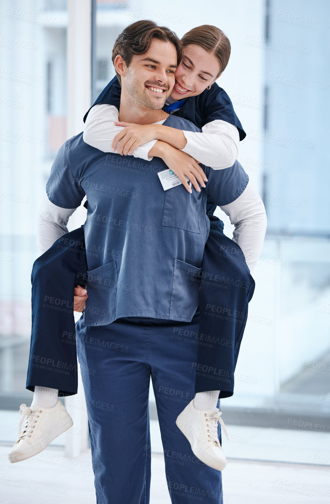 Buy stock photo Couple, hospital and doctors piggy back for love, happy relationship and work romance in clinic. Healthcare team, dating and playful man and woman for medical service, support and medicare career