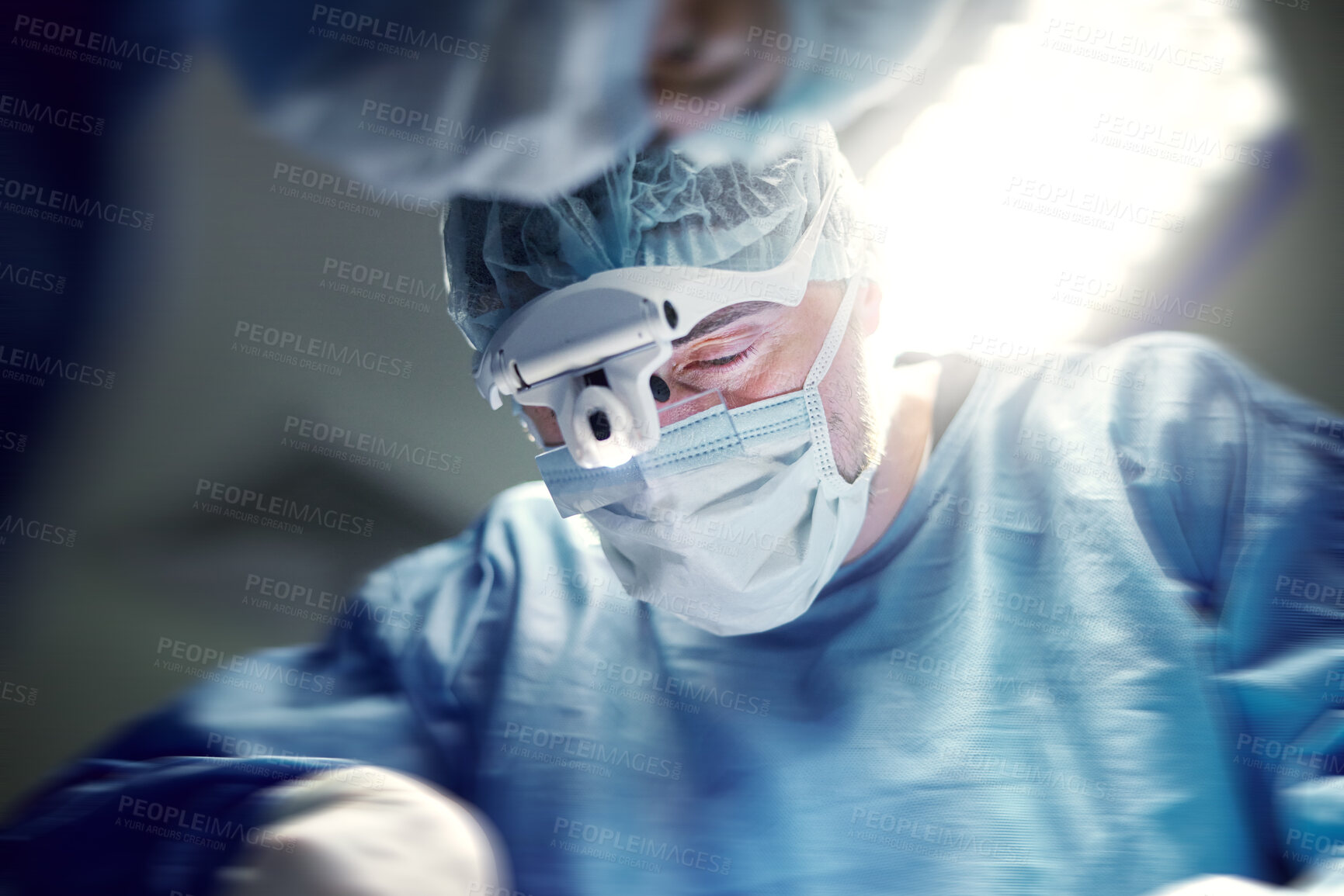 Buy stock photo Headlight, healthcare and doctors in a hospital for surgery together, working in theater to save a life. Medical, teamwork and a surgeon in the operating room of a clinic for an operation closeup