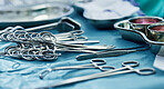 Background, surgery and metal tools in operating room for hospital assessment, healthcare analysis or emergency in medical theatre. Closeup, surgical equipment and scissors with forceps for operation