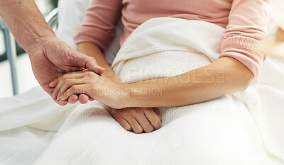 Buy stock photo Cropped shot of an unidentifiable doctor holding his patient's hand in the clinic