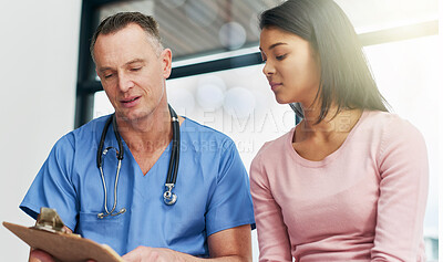 Buy stock photo Shot of a doctor consulting with his patient in the hospital